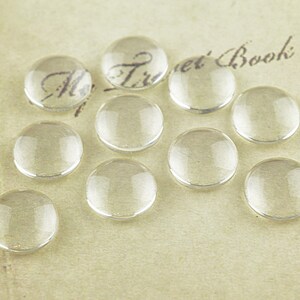 0.23 EUR/piece. Cabochons 10 mm glass clear 10 pieces