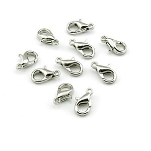 May include: Ten silver-toned lobster clasps, a type of fastener used for jewelry making.