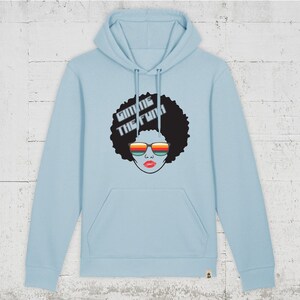 Könnte beinhalten: Ein hellblauer Hoodie mit einem Aufdruck einer Frau mit Afrofrisur, die eine Sonnenbrille trägt, und dem Text "Gimme the Funk" auf der Vorderseite.