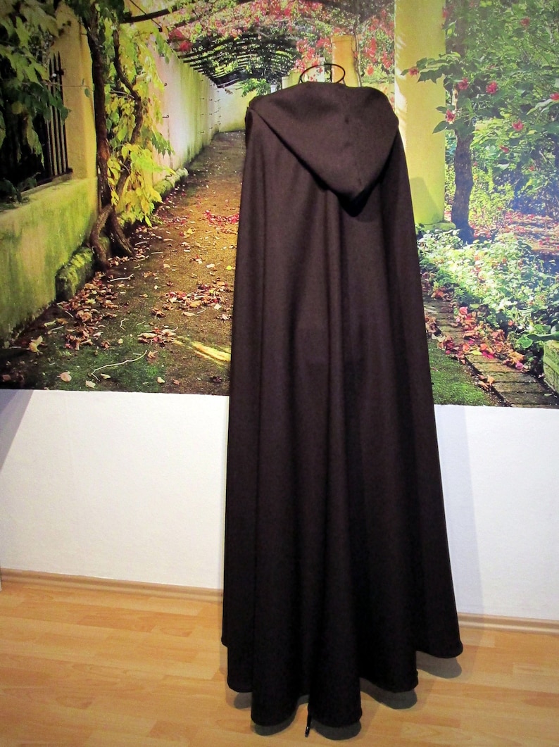May include: A brown hooded cloak with a long, flowing design. The cloak is made of a soft, comfortable fabric and has a simple, elegant style.
