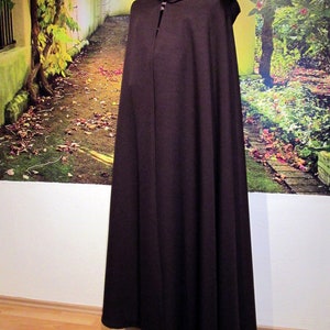 May include: A brown hooded cloak with a long, flowing design. The cloak is made of a soft, comfortable fabric and has a simple, elegant style.