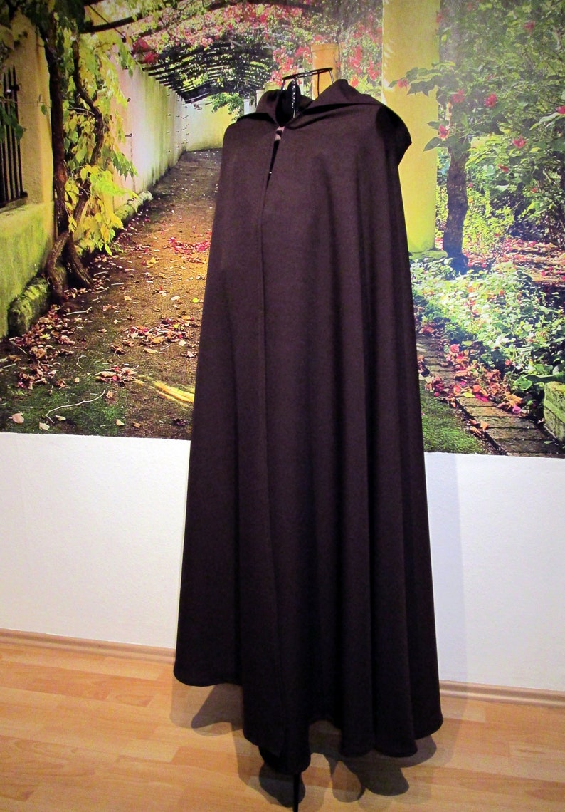 May include: A brown hooded cloak with a long, flowing design. The cloak is made of a soft, comfortable fabric and has a simple, elegant style.