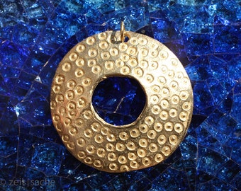 Transition pendant dotted disc with hole brass from Africa archaic rite of passage life death rebirth