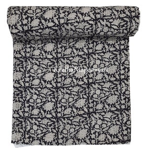 May include: A black and white kantha quilt with a floral pattern. The quilt is rolled up and the text "Kantha Tapestry Art" is visible in the center of the image.