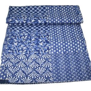 May include: A blue and white kantha quilt with a patchwork design. The quilt is made of cotton and has a hand-stitched look.