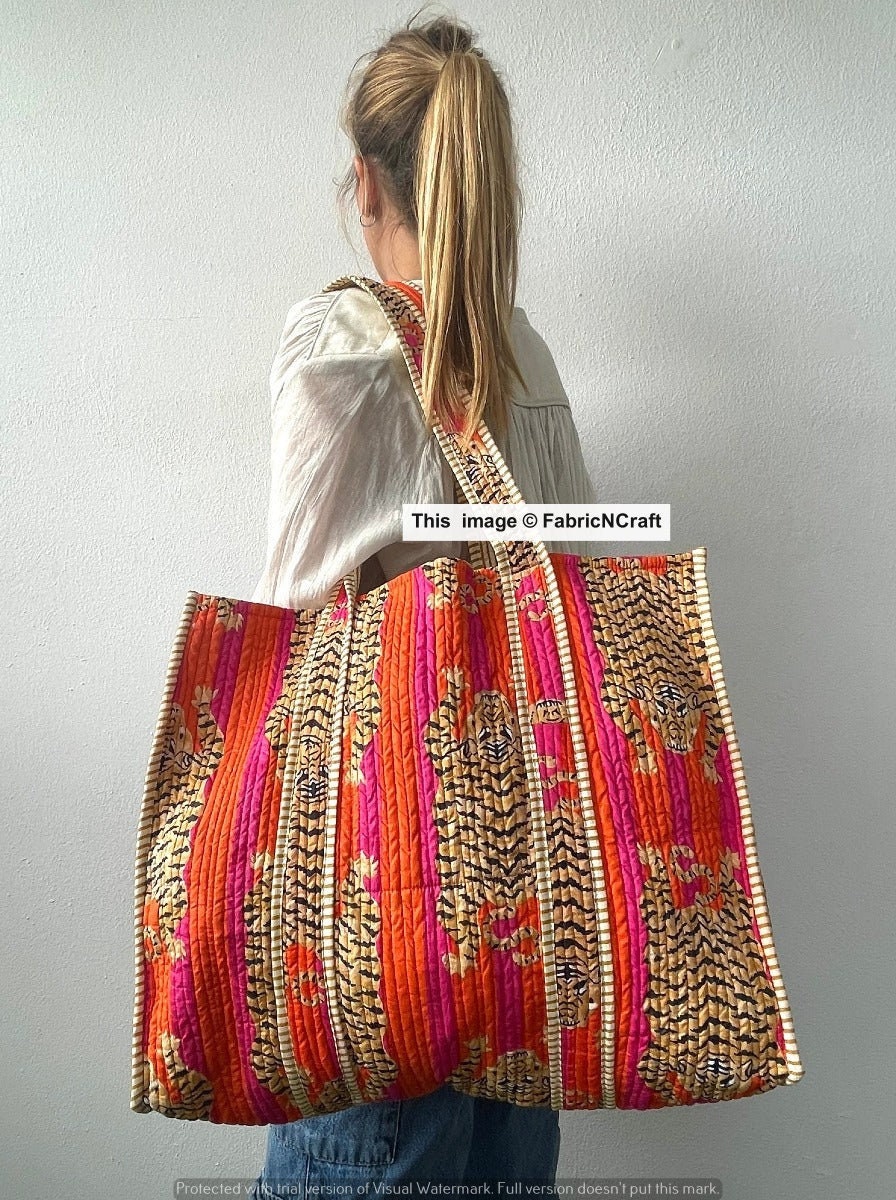 Anoma by Puja - Jhola Bag made in cotton textured fabric; multicolored  embroidery at center and decorated with braid tape, crochet lace and  handmade tassels. The framing is done with soft cord