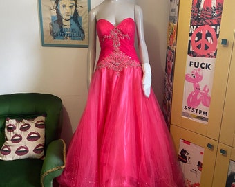 Bright pink prom dress with bead detailing.