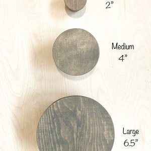 May include: Three wooden wall hooks in different sizes: small (2 inches), medium (4 inches), and large (6.5 inches).