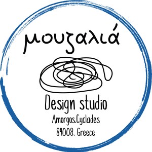May include: A circular logo with a blue brushstroke border containing a black line drawing of a tangled thread. The text reads "&mu;&omicron;&upsilon;&zeta;&alpha;&lambda;&iota;ά", "Design studio", "Amorgos, Cyclades", and "84008, Greece" in black lettering on a white background.