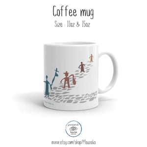 May include: A white ceramic coffee mug featuring a graphic of four stylized figures walking along a gray cobblestone path. The text Coffee mug and Size: 11oz & 15oz appear above the mug. The figures are colored in blue, brown, and tan.