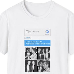 May include: White t-shirt with a printed graphic. The graphic includes a reCAPTCHA box with the text "I'm not a robot" and a prompt to select squares with "Pedophiles or Child Traffickers".
