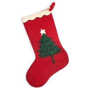 May include: A red felt Christmas stocking with a white scalloped cuff. A green felt Christmas tree and white star are appliqued on the front. A loop of red pom-poms is attached to the top.