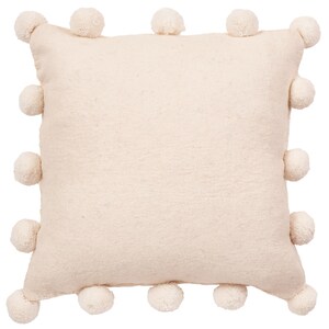 May include: A cream-colored throw pillow with a fluffy pom-pom trim around the edges.
