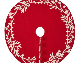 May include: A round, red Christmas tree skirt with a white floral and star design around the edge. The skirt has a center opening and is secured with three red buttons. Festive holiday decor.