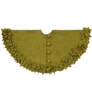 May include: A green felt Christmas tree skirt with a scalloped edge and a row of felt leaves around the bottom. The skirt has five buttons down the center.