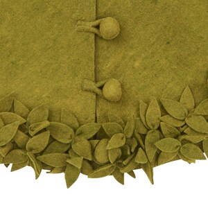 May include: A green felt skirt with a leaf trim. The skirt has two buttons on the front.