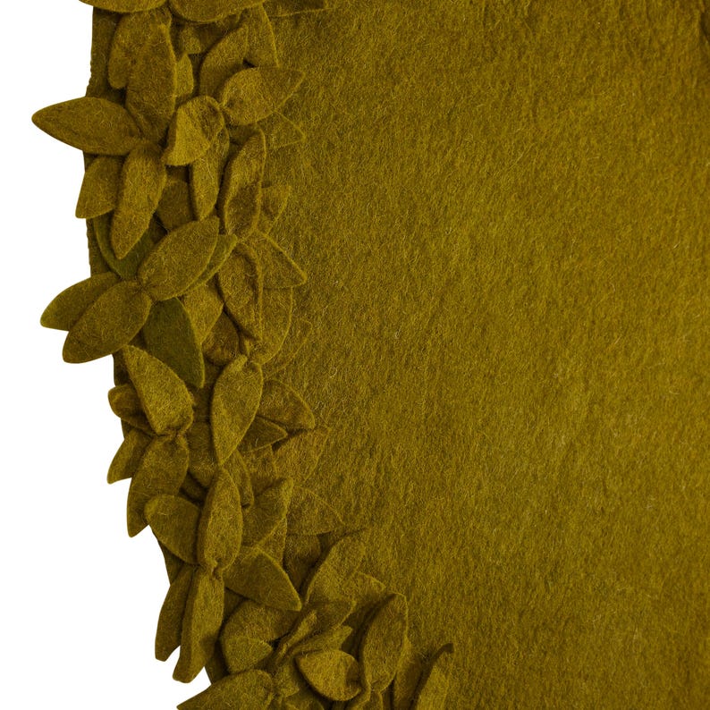 May include: A round, olive green felt rug with a border of 3D felt leaves. The leaves are arranged in a circular pattern around the edge of the rug.
