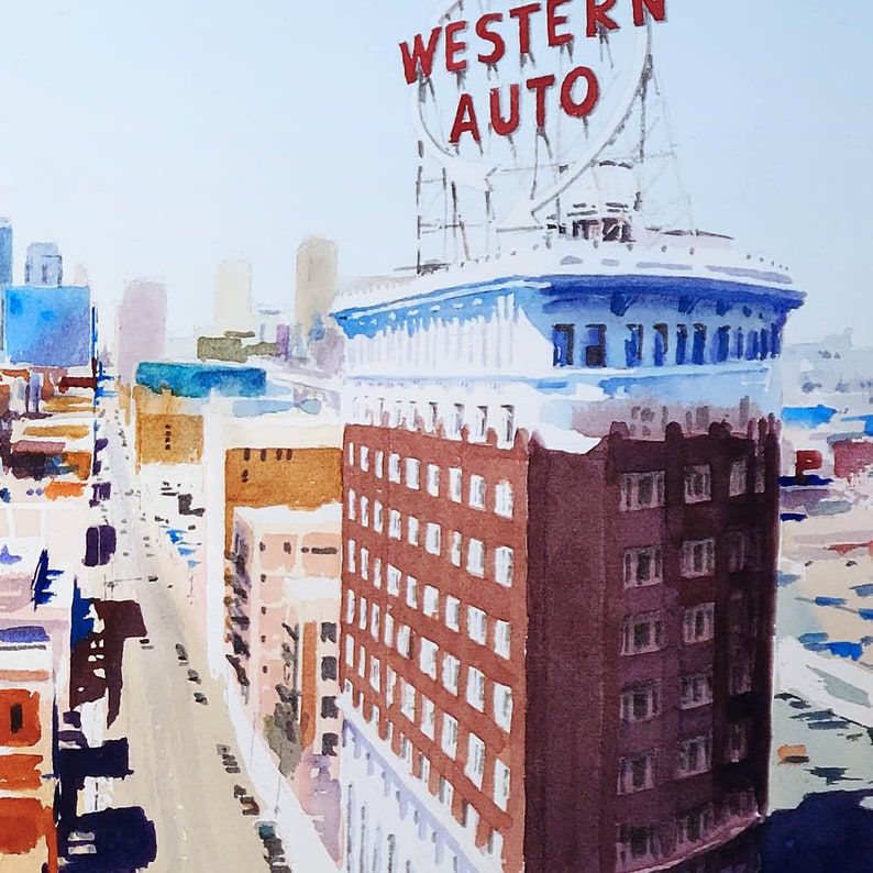 May include: A watercolor painting of a city street scene with a building that has a large sign that says "Western Auto" on it. The building is brown with white trim and has many windows. The street is empty and there are other buildings in the background.