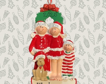 May include: A Christmas ornament featuring a family of four and a dog, all dressed in Santa Claus outfits. The ornament has the names Allen, Kim, Jimmy, and Frank, with the family name Johnson. The year 2025 is also displayed.