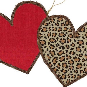 May include: Two heart-shaped burlap ornaments, one red and one with a leopard print pattern. Both are trimmed with brown twigs.