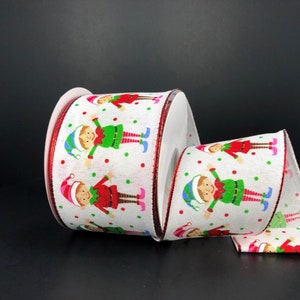 May include: White ribbon with a red edge and a repeating pattern of elves wearing green and red outfits and hats. The elves are standing on a white background with red and green polka dots.