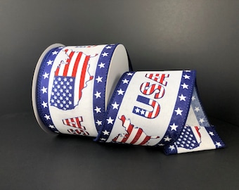 May include: White ribbon with a blue and red American flag design and the word "USA" printed on it. The ribbon is decorated with blue stars.