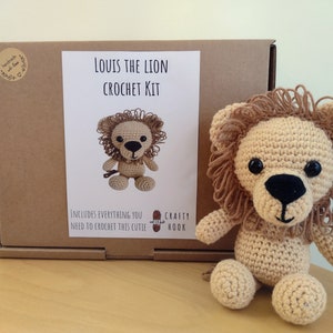 May include: A crochet kit to make a stuffed lion named Louis. The kit includes everything you need to crochet this cutie. The box is brown with a white label that says "Louis the Lion Crochet Kit".