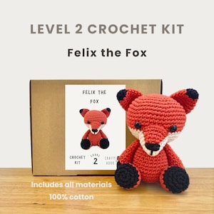 May include: A crochet kit for "Felix the Fox" with a finished fox toy. The kit includes all materials and is level 2. The fox is red with black and white accents. The text on the box reads "Felix the Fox" and "100% cotton."