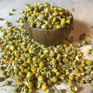 Wooden bowl and Bulk Chamomile Flowers.