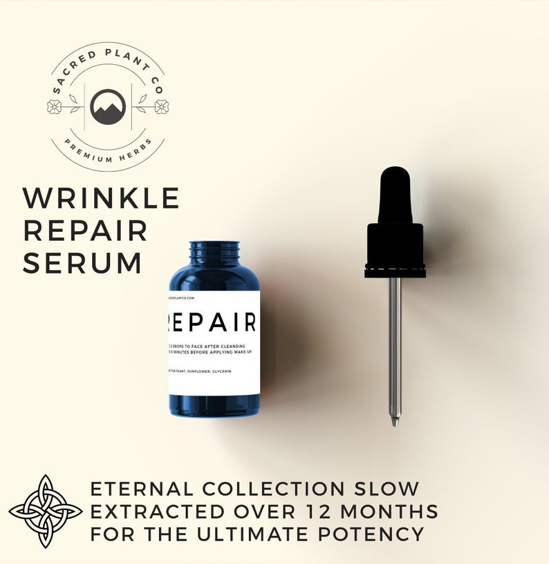 May include: A blue glass bottle with a black label that says "Repair" and a dropper bottle with a black cap and a silver dropper. The bottle is labeled "Sacred Plant Co. Premium Herbs" and "Wrinkle Repair Serum". The text "Eternal Collection Slow Extracted Over 12 Months For The Ultimate Potency" is below the bottles.