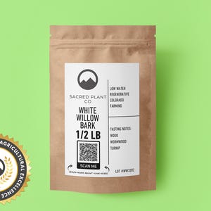 May include: A brown paper bag with a white label that says "Sacred Plant Co. White Willow Bark 1/2 LB". The label also includes a QR code and the text "Scan Me". The bag is on a green background.
