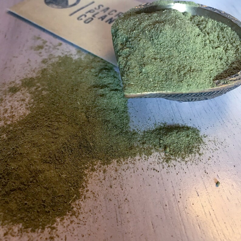 Moringa Powder on white table.