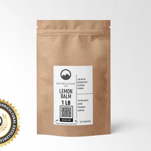 A medium-sized kraft paper bag labeled Sacred Plant Co Lemon Balm 1 LB, offering premium quality herbs for tea or tinctures. Highlighted with tasting notes of lemon, spearmint, and camphor and a focus on sustainable farming practices in Colorado.