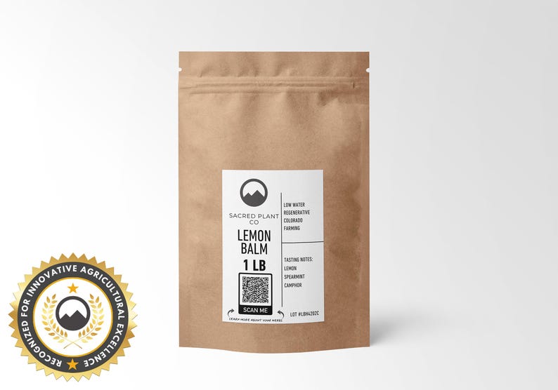 A medium-sized kraft paper bag labeled Sacred Plant Co Lemon Balm 1 LB, offering premium quality herbs for tea or tinctures. Highlighted with tasting notes of lemon, spearmint, and camphor and a focus on sustainable farming practices in Colorado.