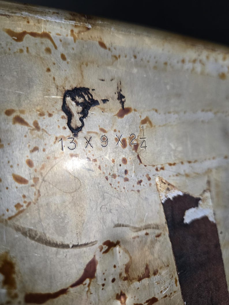 May include: A white ceramic mug with a black handle and the text "But First, Coffee" in a black, handwritten-style font. The mug is on a white surface.