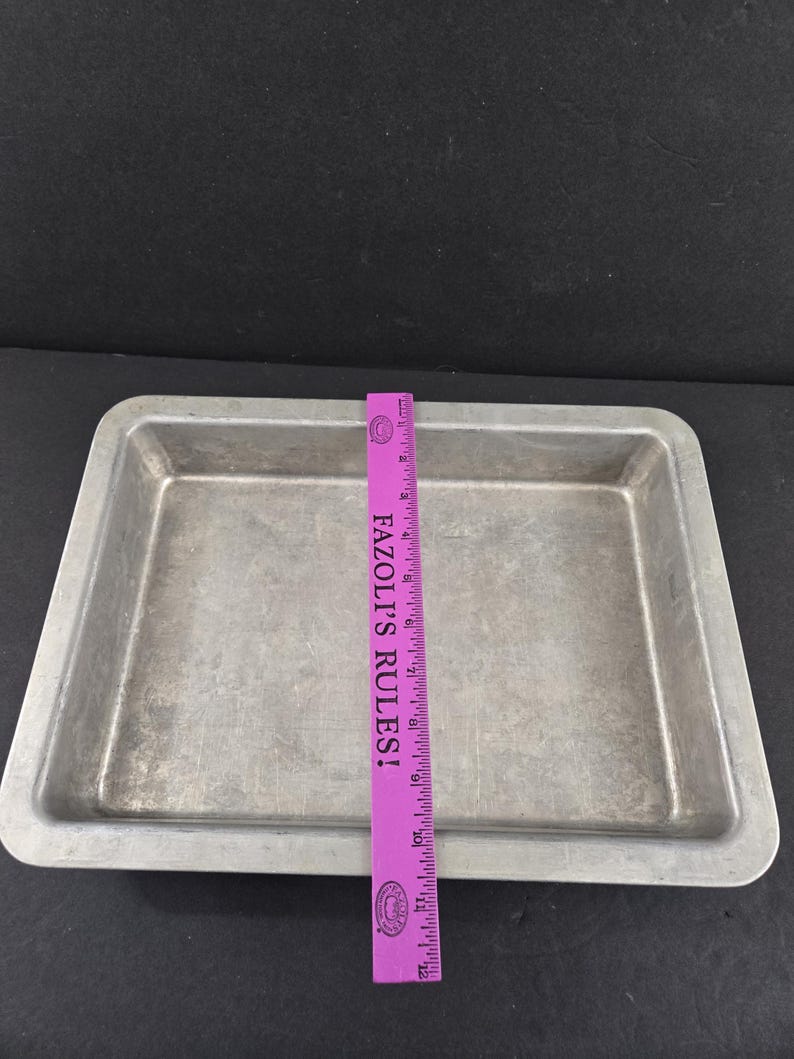 May include: A white ceramic mug with a black handle and the text "But First, Coffee" in a bold, black font. The mug is set against a neutral background, highlighting its simple design.