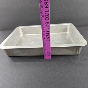 May include: A set of three ceramic mugs with a speckled, cream-colored glaze. Each mug features a different hand-painted floral design in shades of blue, green, and yellow. The mugs have a simple, rounded shape.