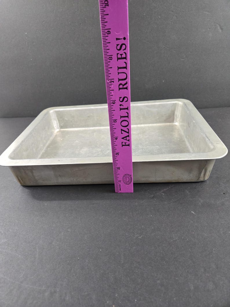 May include: A set of three ceramic mugs with a speckled, cream-colored glaze. Each mug features a different hand-painted floral design in shades of blue, green, and yellow. The mugs have a simple, rounded shape.