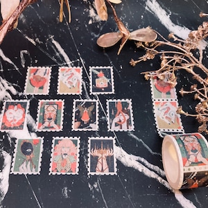 May include: A collection of decorative stamps and a roll of matching washi tape featuring whimsical illustrations. The stamps and tape showcase various designs with a vintage aesthetic, including figures, botanicals, and abstract elements. The color palette includes muted greens, reds, and creams.
