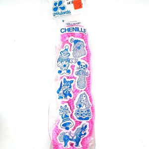 May include: A package of pink chenille stems with blue and white sticker embellishments featuring various cartoon characters. The package is sealed in clear plastic and includes the text "CHENILLE".