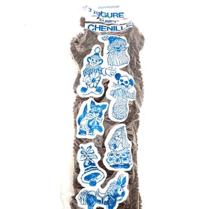 May include: A package of brown chenille with blue and white figure stickers. The stickers include a gnome, Santa Claus, a mouse, a dog, a girl, a bell, and a donkey. The package has the text "FIGURE BUMPY CHENILLE".