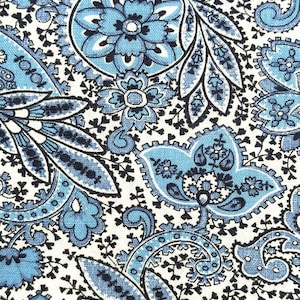 May include: A textile fabric featuring a dense paisley pattern in shades of light blue, medium blue, and black on a white background. The design consists of intricate floral motifs, swirling teardrop shapes, and small leaf-like elements.