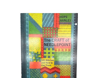 May include: A book titled "The Craft of Needlepoint" by Hope Hanley. The cover features a colorful patchwork design with various stitch patterns in shades of green, yellow, red, and blue. The book also includes the text "101 Stitches and How to Use Them."