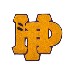 May include: A chenille varsity letter patch featuring the letters HP in gold with a dark purple border. The letter H has two dark purple horizontal stripes on the top left vertical bar, and the entire design has a textured, fuzzy surface finish.