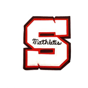 May include: A white felt letter "S" patch with a red border and a brown outline. The word "Mathletes" is embroidered in black script across the center of the letter. The patch is on a white background.