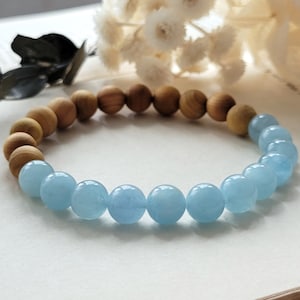 May include: A bracelet made of light blue aquamarine beads and brown wood beads.