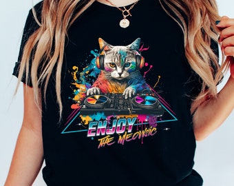 May include: Black t-shirt with a colorful graphic of a cat wearing headphones and mixing music on a DJ mixer. The text "ENJOY THE MEOWSIC" is printed below the cat.