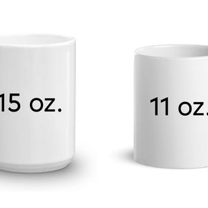 May include: Two white ceramic mugs, one with "15 oz." printed on it and the other with "11 oz." printed on it.