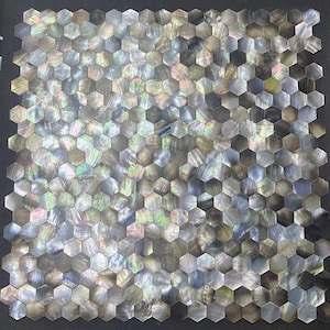 May include: A sheet of iridescent black hexagonal mosaic tiles. The tiles are made of mother of pearl and have a subtle shimmer.