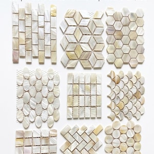 May include: Nine small samples of iridescent mosaic tiles in various geometric patterns. The samples include rectangular, diamond, oval, and circular shapes, showcasing a range of design options for home decor projects. The text on the image says "USD 29.99/Pack of 9 Small Samples".